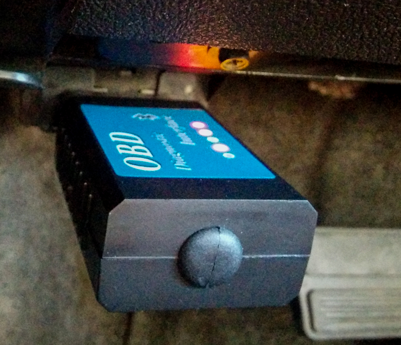 The device is plugged into the OBD (OnBoard Diagnostic) port under the dash.